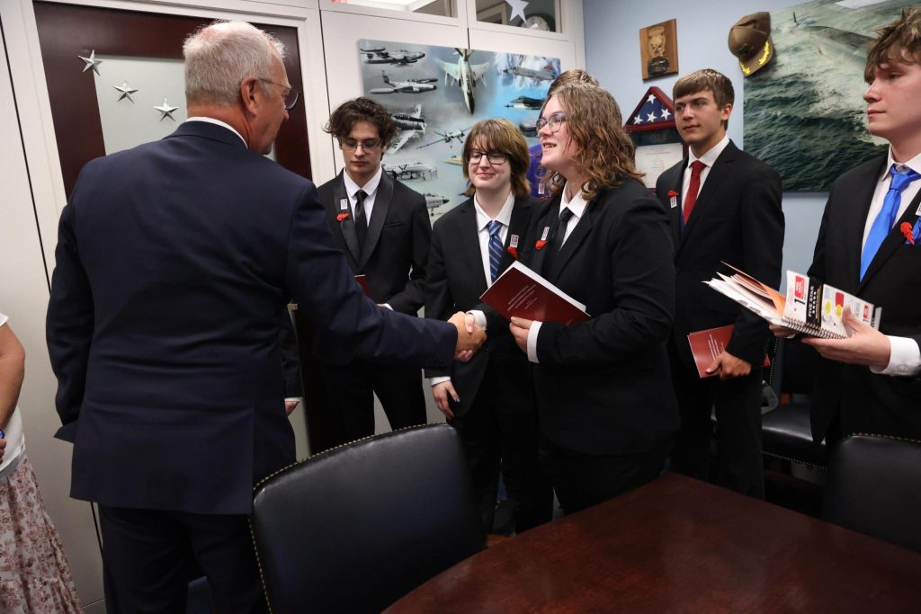 Students in business attire meeting with a member of Congress